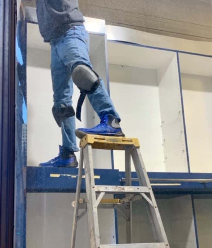 Construction worker using ladder in an unsafe way
