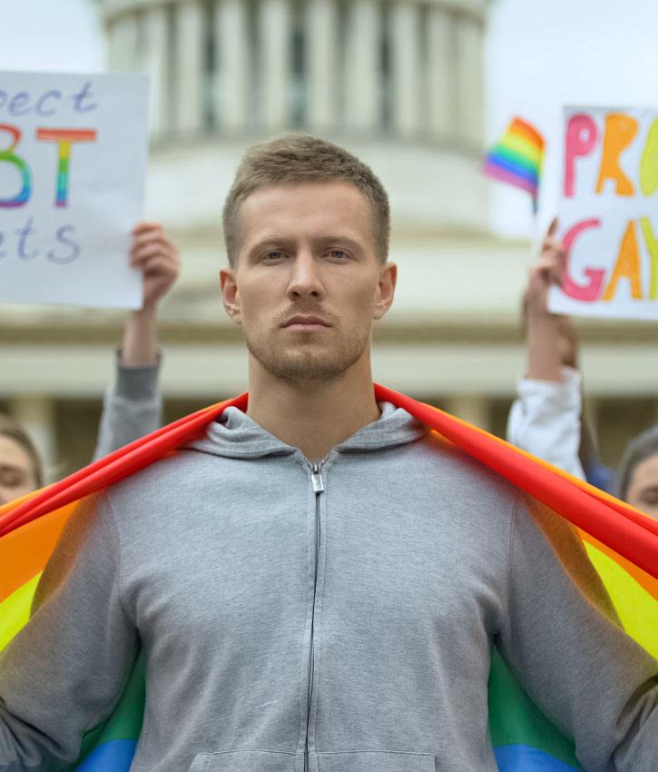 Male holding rainbow flag, fighting for respecting and protecting LGBT rights