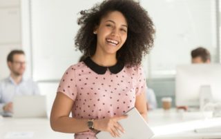 young smiling female African-American intern at work