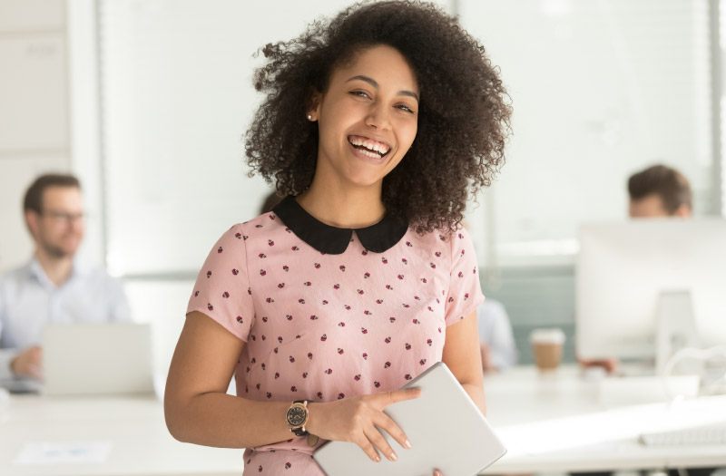 young smiling female African-American intern at work
