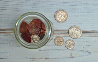 coins on table and in jar