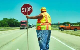Flagger holding sign